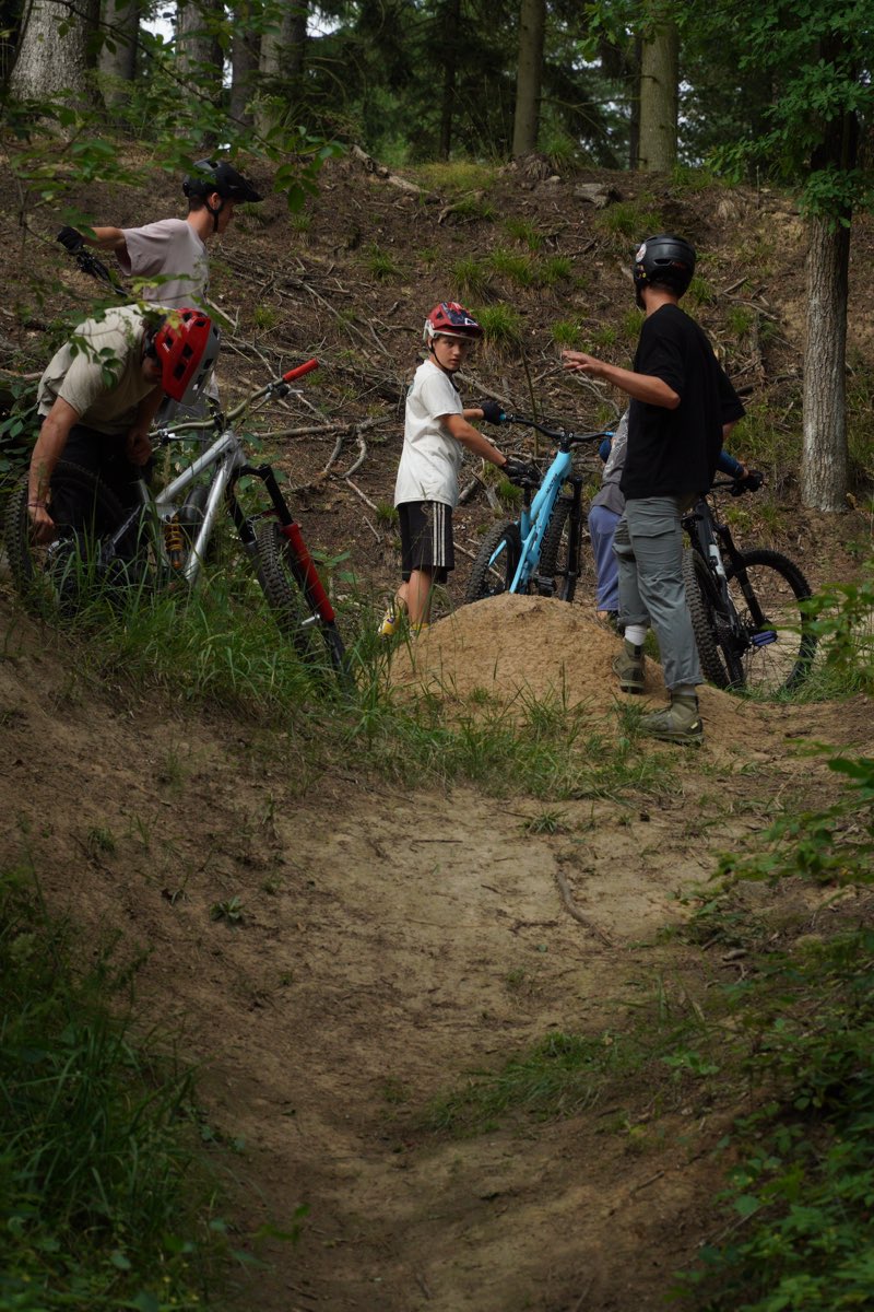 Děti tlačí kola do kopce na trail